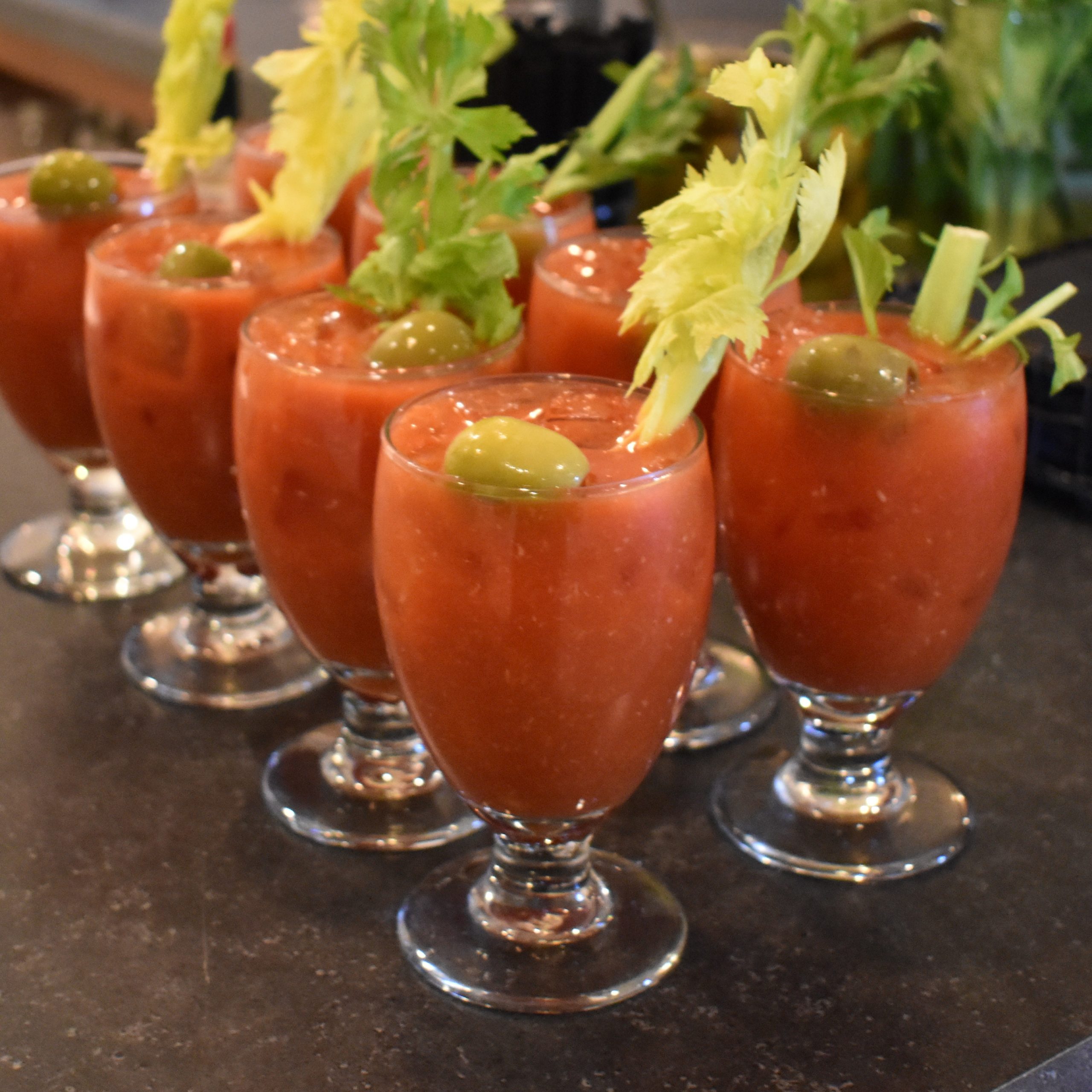 bloody mary Group of bloody mary drinks topped with celery stalks in wine glasses